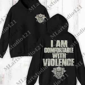 以下が含まれることがあります： 前面にスカルと交差した斧のグラフィックが入った黒いパーカー。背面には「I AM COMFORTABLE WITH VIOLENCE」の文字と、お揃いのスカルグラフィックが描かれています。フード付きスウェットシャツ。