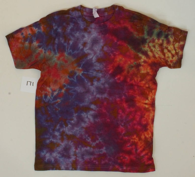 May include: A tie-dye t-shirt with a swirling pattern of purple, red, orange, and brown colours.