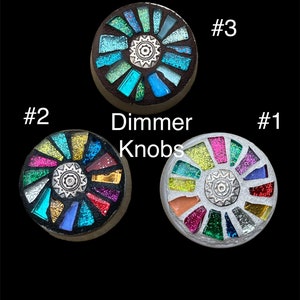 May include: Three round, colorful, mosaic-style dimmer knobs with a silver center. The knobs are labeled #1, #2, and #3. The text "Dimmer Knobs" is also included in the image.