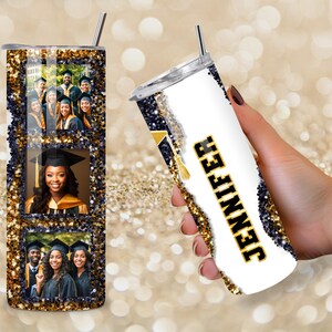 May include: A personalized graduation tumbler with a photo collage and the name "Jennifer" in black and gold. The tumbler has a glittery gold and navy blue design, a silver straw, and images of graduates.