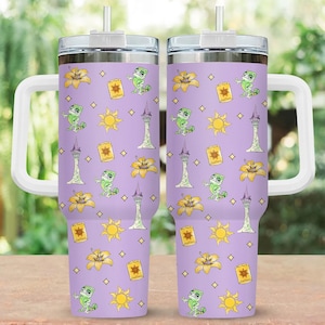 May include: Two stainless steel tumblers with white handles and straws. The tumblers have a lavender background with a repeating pattern of yellow flowers, suns, lanterns, a chameleon, and a tower.