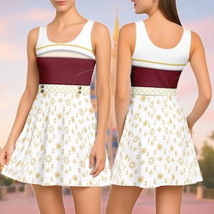 May include: A sleeveless dress featuring a white bodice with gold trim, a burgundy midsection, and a white skirt with a gold pattern. The dress has a scoop neckline and a fitted waist. The skirt is flared, and the overall design is whimsical and elegant.