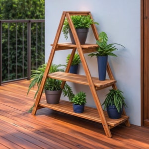 May include: A wooden plant stand with three shelves, featuring a variety of potted plants, including ferns, succulents, and leafy greens. The stand is made of natural wood and has a rustic, farmhouse style.