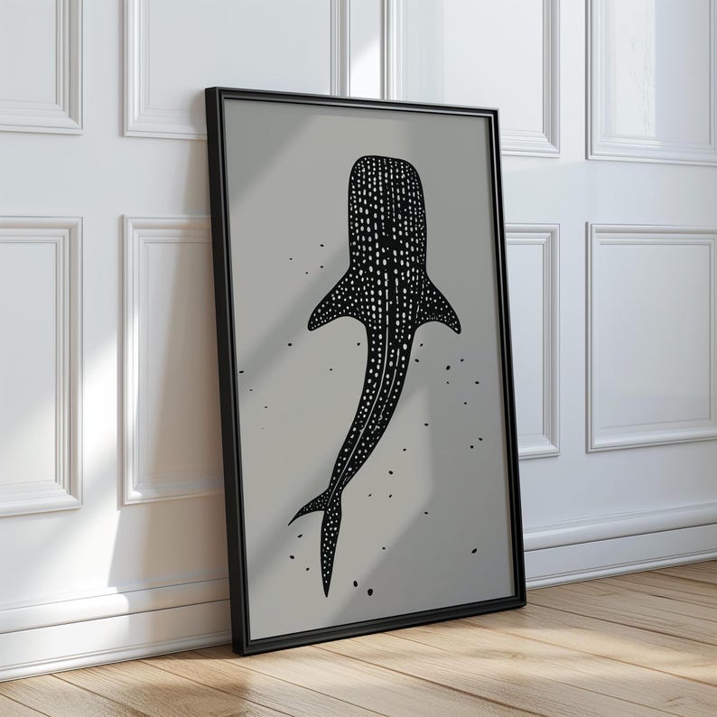 Minimalist illustration print depicting a whale shark swimming in the ocean in an elegant manner, the shark is drawn in a black color with white dots and the background is a beige color with black ink spots