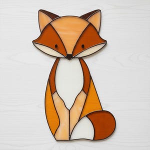 May include: A stained glass fox with a geometric design. The fox features shades of orange, brown, and white, with black eyes and a dark brown nose. The artwork is a decorative piece, suitable for home decor.