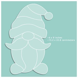 May include: A light blue gnome-shaped design with a white outline, featuring a hat, mustache, and round nose. The image includes the dimensions: approximately 6 x 9 inches.