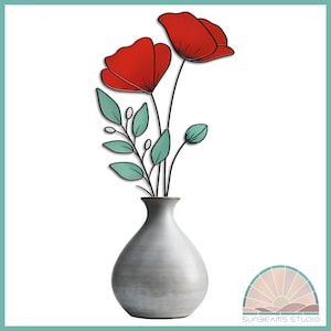 May include: A gray ceramic vase with a rounded body holds a bouquet of red poppies and green leaves.