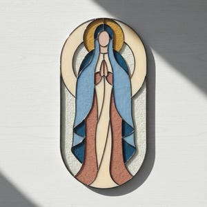 May include: Oval stained glass panel depicting a figure with hands clasped in prayer. The figure wears a blue veil and robe, with a gold halo. The panel features a color palette of blue, beige, and brown, with a black border.