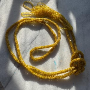 Antique flapper necklace | 1920&#39;s Art Deco long glass beaded lariat style sautoir necklace | yellow hand knotted tubular bead necklace