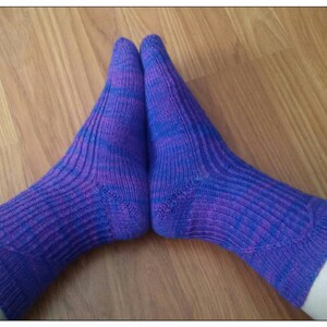 May include: A pair of purple and blue striped socks with a ribbed texture.