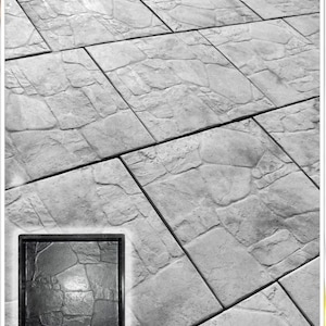 May include: A grayscale image showing a stone-effect surface made of large, rectangular tiles. The tiles have a textured, rough appearance, similar to natural stone. A smaller, square inset displays a close-up of the stone texture.