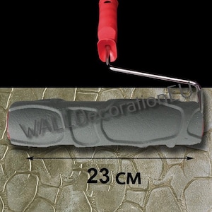 May include: A gray textured paint roller with a red handle. The roller is 23 inches long and has a pattern of small, raised circles. The roller is used to create a textured effect on walls.