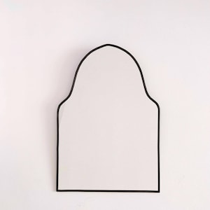 black arch brass mirror in white background