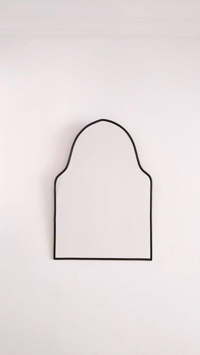 black arch brass mirror in white background