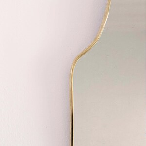 arch brass mirror frame in white background