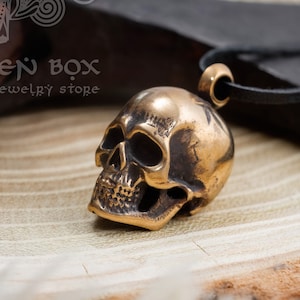 Bronze Human Skull Pendant. The witchy necklace is the perfect gift for Mythology, History, and Antique Enthusiasts.