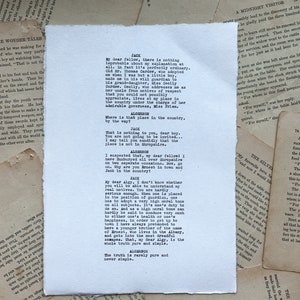 May include: A black and white typed script of a play, featuring dialogue between two characters, Jack and Algernon. The text includes the lines "My dear fellow, there is nothing improbable about my explanation at all." and "The truth is rarely pure and never simple."
