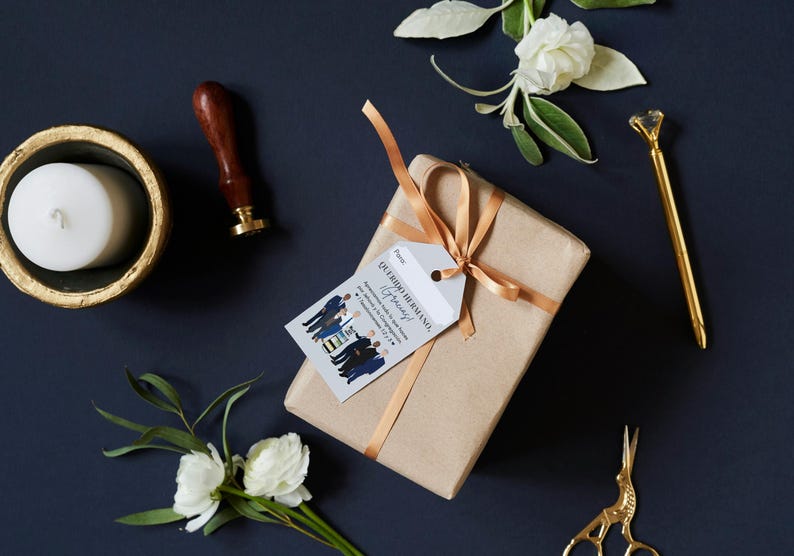 May include: A brown gift box with a gold ribbon and a white gift tag that says "Our Big Husband Anniversary" with a cartoon illustration of a group of men in suits.