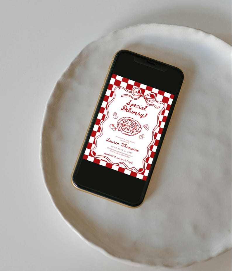 May include: A smartphone displays a red and white checkered pizza-themed invitation. The invitation features the text "Special Delivery!" and the name "Lauren Thompson". The phone rests on a white, round plate.