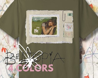 May include: A green t-shirt with a collage of images and the text "BE4TOPIA 4 COLORS" printed on the front.