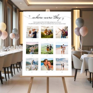 May include: A white sign on a wooden easel with the text "where were they" and nine photos. The sign is for a wedding game. The photos show couples in various locations. Balloons and tables are in the background.