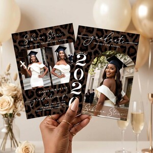 May include: Two graduation announcements held by a hand. The announcements feature a photo of a graduate in a white dress and cap. The background has a leopard print design. Text includes the graduate's name, school, and graduation details.