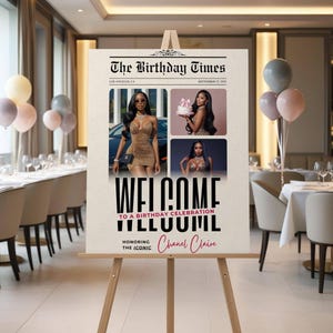 May include: A wooden easel displays a newspaper-style sign for a birthday celebration. The sign features photos of a woman in a leopard print dress, the headline "The Birthday Times," and the name "Chanel Claire" in pink script. Balloons decorate the background.