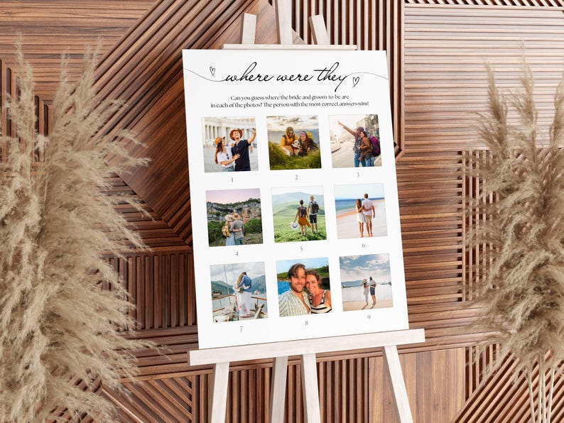 May include: A white sign on a wooden easel with the text "where were they" and nine small photos. The sign is for a wedding game. The background is a wooden wall with dried plants.