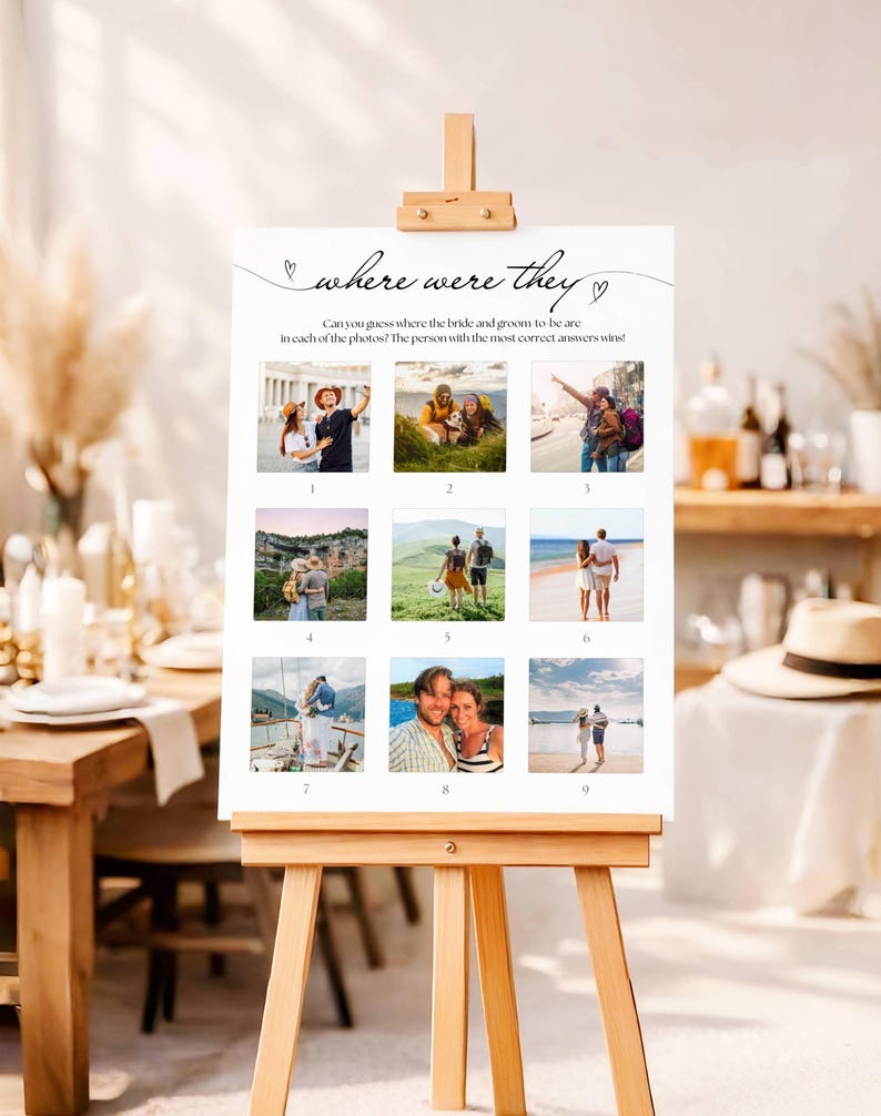 May include: A white sign on a wooden easel with the text "where were they" and nine small photos. The sign is for a wedding game, asking guests to guess the locations in the photos.