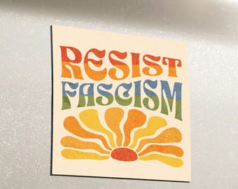 May include: A white car with a "Resist Fascism" sticker on the back. The sticker features a rainbow-colored sunburst design.