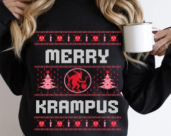 May include: Black sweatshirt with a festive "Merry Krampus" design. The design includes red skulls, candles, Christmas trees, and a red Krampus figure. The text is in white, and the overall style resembles a holiday sweater.