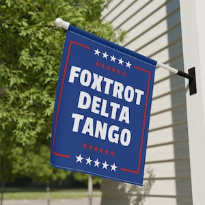May include: A blue flag with white stars and red stripes. The flag has the text "FOXTROT DELTA TANGO" in white letters.