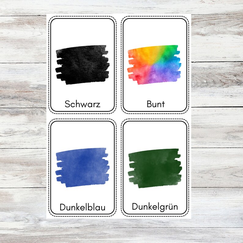 May include: Four flashcards with different colored swatches and German words for the colors. The colors are black, rainbow, dark blue, and dark green. The words are "Schwarz", "Bunt", "Dunkelblau", and "Dunkelgr&uuml;n".