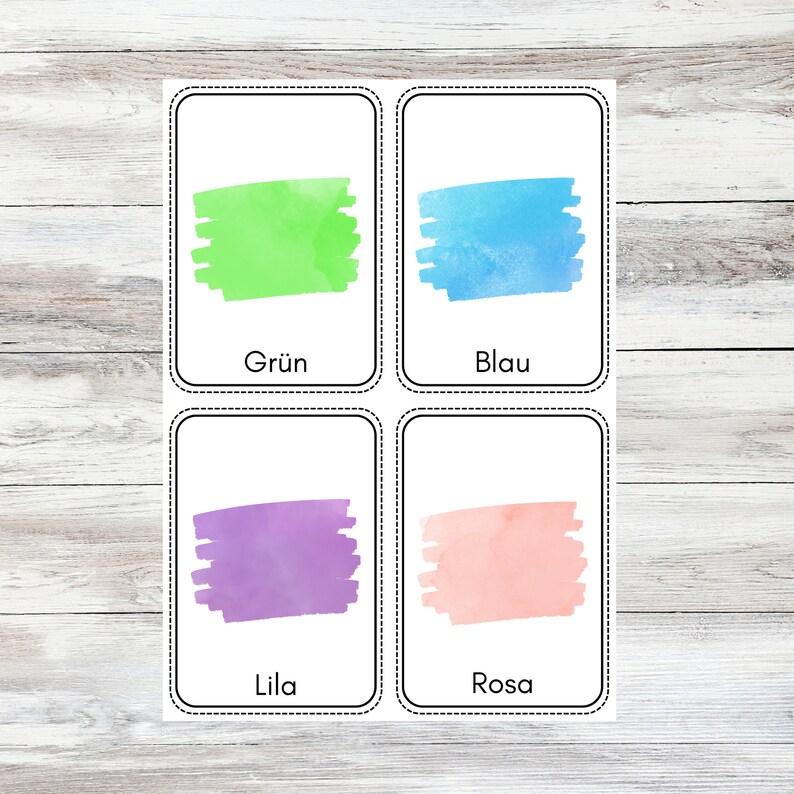 May include: Four color cards with watercolor swatches and German words for the colors: Gr&uuml;n (green), Blau (blue), Lila (purple), and Rosa (pink).