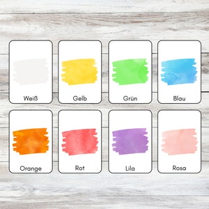 May include: Eight color cards with watercolor swatches and German color names. The colors are white, yellow, green, blue, orange, red, purple, and pink.