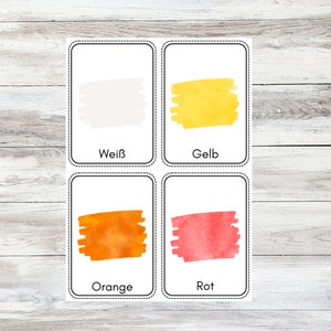 May include: Four color cards with watercolor swatches. The cards are labeled "White", "Yellow", "Orange", and "Red".