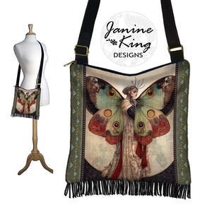 May include: A green, black, and white fabric shoulder bag with a fringe trim. The bag features a large butterfly design with a woman in a white dress and red accents. The bag has the text "Janine King Designs" on it.