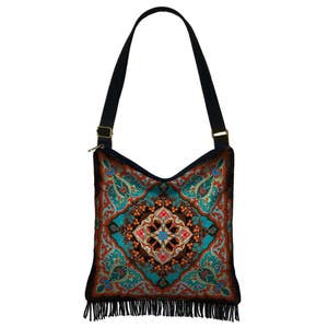 May include: A blue, orange, and green patterned shoulder bag with a fringe trim. The bag has a black strap and a gold buckle.