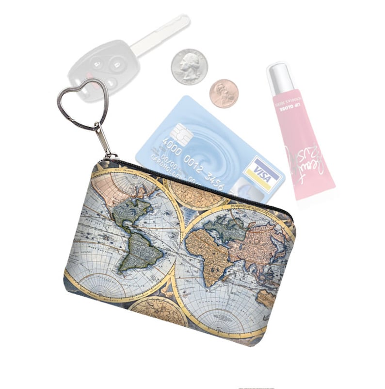 May include: A small zippered pouch with a world map print. The pouch has a heart-shaped zipper pull and is filled with various items, including a credit card, lip gloss, and keys.