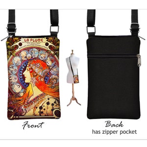 May include: A black canvas crossbody bag with a zipper pocket on the back. The front of the bag features a colorful illustration of a woman with red hair and a crown, surrounded by zodiac symbols. The text "LA PLUME" is printed on the bag.