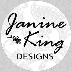 May include: Black and white logo with the text "Janine King DESIGNS" on a white background with a paisley pattern.