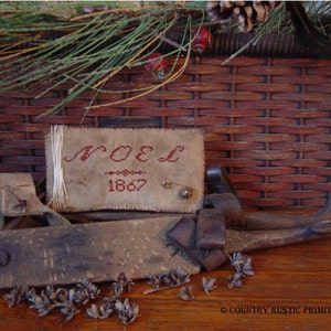 Patrón de punto de cruz primitivo de Noel Pinkeep en formato PDF