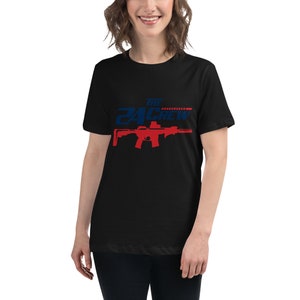 May include: Black t-shirt with a red and blue graphic of a rifle and the text "THE 24 CREW".