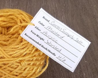 May include: A skein of Caron Simply Soft yarn in the color Mustard. The yarn is acrylic and worsted weight. The recommended hook size is H/8.