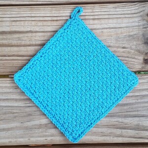 May include: A bright turquoise blue crocheted pot holder with a loop for hanging.
