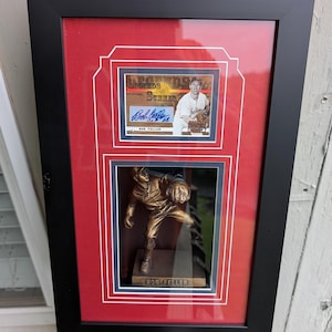 Autographed Bob Feller Cleveland Guardians 2003 Donruss Baseball card in a shadow box display featuring a Bob Feller Statue.