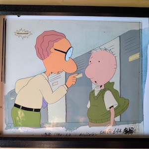 May include: Framed animation cel featuring two cartoon characters. One character, with pink skin, glasses, and a white shirt, points at a card. The other character, with pink skin and a green vest, looks surprised. The Nickelodeon logo is visible.