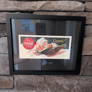 Vintage Coca-Cola 1953 Advertising Ink Blotter featuring a Nymph and the slogan Drink Coca-Cola in bottles. Framed 8x10 inches