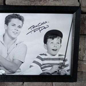 May include: Black and white photo of two boys, one with a fishing rod, signed "Take Care, Tom Bosley".