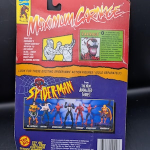 May include: A Spider-Man action figure package featuring the title "Maximum Carnage" in large, bold letters. The package includes images of Carnage and other characters from the animated series, with text describing the figure's features.